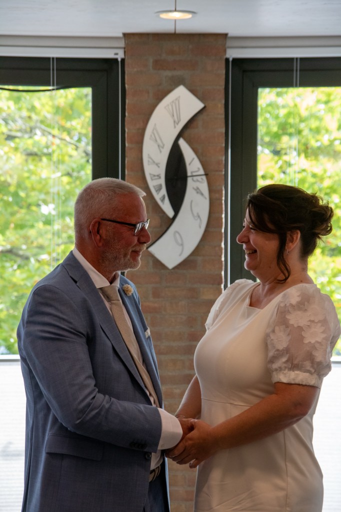 Couple holding hands at a wedding ceremony